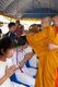 Thailand: Thai Buddhist ordination ceremony, Chiang Mai. Firstly the <i>nak</i> or monk-to-be has his head shaved. The first trimmings are made by parents, relatives or a senior monk