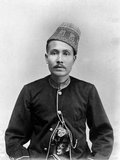 The Aceh War, also known as the Dutch War or the Infidel War (1873–1914), was an armed military conflict between the Sultanate of Aceh and the Netherlands which was triggered by discussions between representatives of Aceh and the United Kingdom in Singapore during early 1873.<br/><br/>

The war was part of a series of conflicts in the late 19th century that consolidated Dutch rule over modern-day Indonesia.<br/><br/>

Sultan Alauddin Muhammad Da'ud Syah II (1864 – 6 February 1939) was the thirty-fifth and last sultan of Aceh in northern Sumatra. He reigned from 1875 to 1903 in opposition to the Dutch colonial state. He surrendered to the Dutch in 1903.<br/><br/>

The Dutch provided the sultan with a comfortable house and a monthly allowance of 1,200 guilders. In 1907 it was revealed that the sultan had secretly helped plan attacks on Dutch positions. The colonial authorities therefore resolved to exile him to Java and from thence to Ambon. In 1918 he was allowed to settle in Meester Cornelis (Jatinegara) in Batavia (Jakarta). The ex-sultan died there on 6 February 1939 and is buried in Rawamangun.