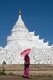 Burma / Myanmar: A traditionally attired Burmese woman carrying a parasol admires the Hsinbyume Pagoda, close to the Mingun Pahtodawgyi (Mingun Temple), Sagaing District, near Mandalay