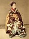 Japan: A Kyoto <i>maiko</i> or apprentice geiko wearing an elaborate dove kimono, Kusakabe Kimbei, c. 1885