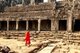 Cambodia: Two monks in the late afternoon light walk past the south inner gallery and central sanctuary of the Bayon, Angkor Thom, Angkor