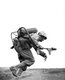 USA / Japan: A US marine carrying a flame-thrower sprints towards a Japanese pillbox at Motoyama Airfield, Iwo Jima,