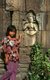 Cambodia: Young Khmer girl in front of an Apsara (Celestial Nymph), Wat Nokor Bayon, Banteay Prey Nokor, Kompong Cham