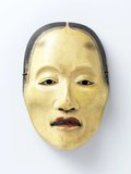 This mask for Japanese Noh theatre is worn by the actor who plays the character Yase Onna, or ‘Emaciated woman’.<br/><br/>

She is the ghost of a woman who suffered a tragic love affair during her life and whose soul is tormented by the loss of her lover.