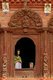 Nepal: An elaborately carved wooden window with portraits of assassinated King Birendra (1945 - 2001), 11th King of Nepal, and Queen Aishwarya, the Shiva Parvati Temple, Durbar Square, Kathmandu