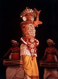 According to legend, the origins of Kandyan dance lie in an exorcism ritual known as the Kohomba Kankariya, which was originally performed by Indian shamans who came to Sri Lanka.<br/><br/>

It was originally performed by dancers who were identified as a separate caste under the Kandyan feudal system. They were aligned to the Temple of the Tooth and had a significant role to play in the Dalada Perahera (procession) held each year by the temple.<br/><br/>

Even though originally only males were allowed train as dancers, there are now several schools which also train women in the Kandyan dance form. However there is no definite Ves costume for women, and many female dancers have adapted the male costume in different ways.