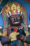 The Kala Bhairav or Black Bhairav is a 3m-high statue depicting a sword-wielding, terror-inducing manifestation of Shiva trampling on some unfortunate victim. Local lore has it that the image was found on the Nagarjun mountain on the western rim of the Kathmandu Valley and brought to its current place by King Pratapa Malla.<br/><br/>

Once the image was set up in Durbar Square, royal courtiers had to swear oaths of allegiance in front of it and witnesses in criminal cases had to testify in its presence. It was believed that anybody telling lies in front of Kala Bhairav would immediately die. Kala Bhairav also demanded blood sacrifices and until today numerous animals are slaughtered in front of the figure during the festival of Dassain.<br/><br/>

Bhairava sometimes known as Kala Bhairava, is a Hindu deity, a fierce manifestation of Shiva associated with annihilation. He originated in Hindu mythology and is sacred to Hindus, Buddhists and Jains alike. He is worshipped in Nepal, Rajasthan, Karnataka, Tamil Nadu and Uttarakhand.