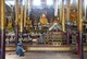 Burma / Myanmar: A man rests in front of the Shan-style Buddhas at the May Nigone Mon Monastery, Inle Lake