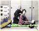 Japan: Blind masseur practising shiatsu or traditional massage on a young woman. Studio portrait, 1890s