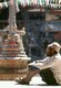 Nepal: A man sits in front of a chaitya (small Buddhist shrine) in the Rudra Varna Mahavihar temple, Patan, Kathmandu Valley (1998)