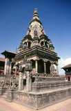 The Vatsala Temple, a few metres southeast of the Bhupatindra Pillar, was built in 1672 CE by Jagatprakasha Malla. Its most conspicuous feature is a bell, about four feet high and set in a massive stone frame, which was added by Ranajit Malla in 1737. The bell was rung to call the faithful to the morning prayers conducted for the goddess Taleju.