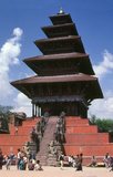 This Nyatapola Temple was built in 1708 by King Bhupatrindra Malla (r. 1696 - 1722). Bhupatindra placed a <i>chudamani</i> (a jewel worn in a head-dress) in the foundation to give the temple supernatural strength, and started the construction by personally carrying three bricks to the site. The king’s example spurred the populace into rapid action, and within five days the people of Bhaktapur had brought together all the materials necessary for the work.<br/><br/>

In the earthquake of 1934, when all buildings around were shaken to the core and many were completely destroyed, the Nyatapola Temple escaped almost unscathed.<br/><br/>

The Nyatapola Temple was most likely dedicated to the mysterious Tantric goddess Siddhi Lakshmi, whom it was hoped would neutralise the negative influence of the adjacent Bhairavnath.