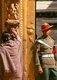 Nepal: A soldier guards the Golden Gate (Sun Dhoka) leading to the Taleju Temple within the Royal Palace complex while a woman pays homage to a deity, Bhaktapur, Kathmandu Valley (1997)