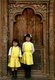 Nepal: Two schoolgirls stand in front of a door at the Pujari Math (formerly living quarters for Hindu priests and now the Woodcarving Museum), Tachupal Tol, or Dattatreya Square, Bhaktapur, Kathmandu Valley (1997)