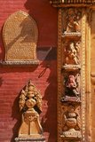 The Golden Gate or Sun Dhoka, marks the entry to the Taleju Temple within the palace complex. The gate was built in 1753 by Ranajita Malla (r. 1722 - 1769) and his wife Jayalakshmi to commemorate the performance of a religious fire rite (kotyahuti-yagya), and it turned out to be the finest piece of gilded copper-work in Bhaktapur, possibly in the whole Kathmandu Valley.<br/><br/>

Highly ornate in itself, the panels left and right of the door, depicting ten different deities, are superb examples of the art of repoussé. On the panels, Ranajita is mentioned as the ruler of a territory that extended as far as the Dudhkoshi River in the east, including the town of Dolakha.<br/><br/>

Above the door, the golden torana shows Taleju Bhavani with her sixteen arms radiating out like some strange kind of half-insect, half-goddess. Above her, at the top of the torana, an image shows the Garuda with serpents coiling all around him.