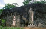 The remote ancient Buddhist site of Buduruvagala (which means ‘stone Buddha images’ in Sinhalese) is thought to date from the 10th century, when Mahayana Buddhism dominated parts of Sri Lanka. Carved into the rock face is a huge 16m-high Buddha figure, with three smaller figures on either side.<br/><br/>

Avalokiteśvara ('Lord who looks down') is a bodhisattva who embodies the compassion of all Buddhas. Portrayed in different cultures as either male or female, Avalokiteśvara is one of the more widely revered bodhisattvas in mainstream Mahayana Buddhism, as well as unofficially in Theravada Buddhism.
