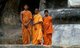Sri Lanka: Young Buddhist monks stand in front of a 1000 year old carved stone 16m Buddha, Buduruvagala