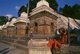 Nepal: A sadhu (holy man) next to the chaityas (small Buddhist shrines) across the Bagmati River next to the Pashupatinath Temple complex, Kathmandu (1997)