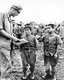 Japan / USA: A US marine talking with captured Japanese child soldiers. Battle of Okinawa, May 1945