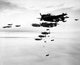 Japan / USA: U.S. Navy Grumman TBM-3 Avengers and Curtiss SB2C Helldivers from the aircraft carrier USS Essex dropping bombs on Hakodate, Japan, in July 1945
