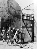 Indian soldiers of the Madras Engineer Group (MEG) try to pull the gates shut at Mandalay Palace (Fort Dufferin) following the Japanese retreat after the Allied British and Indian victory of the Battle of Meiktila and Mandalay during the Burma Campaign. Mandalay, Mandalay Region, Burma (Myanmar). March 1945.