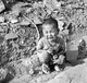 Japan: A Japanese toddler sits crying amidst the rubble left by the explosion in Hiroshima following the dropping of the world's first atomic bomb on the city on 6 August 1945