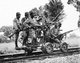 China / Japan: Japanese Imperial Army soldiers with Arisaka Type 38 rifles on a railway hand cart, China, 1937. Asahigraph, September 1937