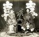 Thomas Child took a series of three photographs relating to late Qing dynasty marriage customs. This one depicts the granddaughter of General Zeng Guofan, a high-ranking Qing official, seated next to her groom.<br/><br/>

Child describes this photograph: 'Weddings are one of the stock ceremonies of the world, and every country has its own customs. In China the bridal colour is scarlet. This bride wore a scarlet satin coat embroidered with gold thread, with a skirt to match, her head dress was a mass of scarlet, gold and pearls.'.