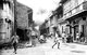 Philippines / USA: Filipino civilians go about their daily routine, whilst others flee down a street with shops engulfed in flames during the Battle of Manila. Metro Manila, Luzon, Philippines. February 1945