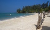Ko Phangan is 15 km (9.5 miles) north of Ko Samui, and, at 168 sq km (65 sq miles) about two-thirds of its size. The island has the same tropical combination of white, sandy beaches, accessible coral reefs and rugged, jungled interior.<br/><br/>

Once the haunt of budget travelers escaping from more expensive Ko Samui, it is today slowly moving more upmarket. Still, the island remains much less developed for international tourism than Ko Samui, due in part to its isolation and in part to its poor infrastructural system. The roads, in particular, remain poor, with many places along the coast only accessible by sea or by pickup truck or motorbike along badly maintained trails.