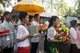 Cambodia: The bride and groom (centre, under parasols) arrive in the early morning at the home of the bride in a village near Siem Reap, central Cambodia
