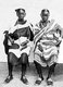 Tanzania / Zanzibar: Two Swahili women wearing kanga wrap-around cotton dress, Dar es Salaam, 1910
