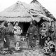 Japan: An Ainu family outside their home somewhere in Hokkaido, c. 1900