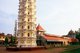 India: The lamp tower (Deep Stambha) and main temple buildings at the Mahalsa Temple, Mardol, Goa
