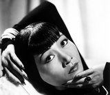 Anna May Wong (January 3, 1905 – February 3, 1961) was an American actress, the first Chinese American movie star, and the first Asian American to become an international star. Her long and varied career spanned both silent and sound film, television, stage, and radio.<br/><br/>

Born near the Chinatown neighborhood of Los Angeles to second-generation Chinese-American parents, Wong became infatuated with the movies and began acting in films at an early age. During the silent film era, she acted in The Toll of the Sea (1922), one of the first movies made in color and Douglas Fairbanks' The Thief of Bagdad (1924). Wong became a fashion icon, and by 1924 had achieved international stardom. Frustrated by the stereotypical supporting roles she reluctantly played in Hollywood, she left for Europe in the late 1920s, where she starred in several notable plays and films, among them Piccadilly (1929). She spent the first half of the 1930s traveling between the United States and Europe for film and stage work.<br/><br/>

Wong was featured in films of the early sound era, such as Daughter of the Dragon (1931) and Daughter of Shanghai (1937), and with Marlene Dietrich in Josef von Sternberg's Shanghai Express (1932). In 1935 Wong was dealt the most severe disappointment of her career, when Metro-Goldwyn-Mayer refused to consider her for the leading role in its film version of Pearl S. Buck's The Good Earth, choosing instead the German actress Luise Rainer to play the leading role. Wong spent the next year touring China, visiting her family's ancestral village and studying Chinese culture.<br/><br/>

In the late 1930s, she starred in several B movies for Paramount Pictures, portraying Chinese-Americans in a positive light. She paid less attention to her film career during World War II, when she devoted her time and money to helping the Chinese cause against Japan. Wong returned to the public eye in the 1950s in several television appearances as well as her own series in 1951, The Gallery of Madame Liu-Tsong, the first U.S. television show starring an Asian-American. She had been planning to return to film in Flower Drum Song when she died in 1961, at the age of 56.