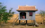In Angkorian times most common folk lived in stilt houses with wooden staircases leading to a single story. Beneath the house, women weaved and domestic animals sheltered. Human waste was commonly deposited through holes in the floorboards to the gratitude of the household's pigs and dogs below.