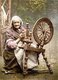 Ireland: An elderly Irish woman seated at her spinning wheel, County Galway, c. 1890