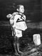 Japan: A young Japanese boy standing at attention after having brought his dead younger brother for cremation Nagasaki, 1945