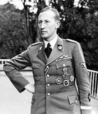Reinhard Tristan Eugen Heydrich (7 March 1904 – 4 June 1942) was a high-ranking German Nazi official during World War II, and one of the main architects of the Holocaust. He was SS-Obergruppenführer und General der Polizei (Senior Group Leader and Chief of Police) as well as chief of the Reich Main Security Office (including the Gestapo, Kripo, and SD).<br/><br/>

He was also Stellvertretender Reichsprotektor (Deputy/Acting Reich-Protector) of Bohemia and Moravia, in what is now the Czech Republic. Heydrich chaired the January 1942 Wannsee Conference, which formalised plans for the Final Solution to the Jewish Question—the deportation and genocide of all Jews in German-occupied Europe.<br/><br/>

Heydrich was attacked in Prague on 27 May 1942 by a British-trained team of Czech and Slovak soldiers who had been sent by the Czechoslovak government-in-exile to kill him in Operation Anthropoid. He died from his injuries a week later. Intelligence falsely linked the assassins to the villages of Lidice and Lezaky. Lidice was razed to the ground; all men and boys over the age of 16 were shot, and all but a handful of its women and children were deported and killed in Nazi concentration camps.