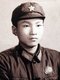 China: Formal portrait of a young 'Red Guard' wearing  a Mao cap with five-pointed red star and a Mao badge on his jacket, c. 1966