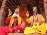 They are known, variously, as sadhus (saints, or 'good ones'), yogis (ascetic practitioners), fakirs (ascetic seeker after the Truth) and sannyasins (wandering mendicants and ascetics). They are the ascetic – and often eccentric – practitioners of an austere form of Hinduism. Sworn to cast off earthly desires, some choose to live as anchorites in the wilderness. Others are of a less retiring disposition, especially in the towns and temples of Nepal's Kathmandu Valley.<br/><br/>

If the Vale of Kathmandu seems to boast more than its share of sadhus and yogis, this is because of the number and importance of Hindu temples in the region. The most important temple of Vishnu in the valley is Changunarayan, and here the visitor will find many Vaishnavite ascetics. Likewise, the most important temple for followers of Shiva is the temple at Pashupatinath. Vishnu, also known as Narayan, can be identified by his four arms holding a sanka (sea shell), a chakra (round weapon), a gada (stick-like weapon) and a padma (lotus flower). The best-known incarnation of Vishnu is Krishna, and his animal is the mythical Garuda.<br/><br/>

Shiva is often represented by the lingam, or phallus, as a symbol of his creative side. His animal is the bull, Nandi, and his weapon is the trisul, or trident. According to Hindu mythology Shiva is supposed to live in the Himalayas and wears a garland of snakes. He is also said to smoke a lot of bhang, or hashish.