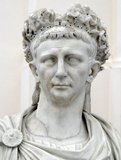 Claudius was the first Roman emperor to be born outside of Italy, and he was ostracised and exempted from public office for much of his life due to slight deafness and being afflicted with a limp. It was his infirmity that would save him from the noble purges that occurred during the reigns of Tiberius and Caligula, as he was not seen as a serious threat.<br/><br/>

Due to being the last surviving man of the Julio-Claudian family, Claudius was declared emperor by the Praetorian Guard after their assassination of Caligula. Despite his only previous experience being sharing a consulship with his nephew Caligula in 37 CE, he proved to be a capable administrator, as well as an ambitious builder across the Empire. The conquest of Britain began under his reign, and his seeming vulnerability meant that Claudius often had to shore up his position, usually through the deaths of rival senators and nobles.<br/><br/>

He was succeeded after his death in 54 CE by his adopted son, Nero.