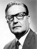 Salvador Guillermo Allende Gossens (26 June 1908 – 11 September 1973) was a Chilean physician and politician, known as the first Marxist to become president of a Latin American country through open elections.<br/><br/>

On 11 September 1973, the military moved to oust Allende in a coup d'etat sponsored by the United States Central Intelligence Agency (CIA). As troops surrounded La Moneda Palace, he gave his last speech vowing not to resign. Later that day, Allende shot himself with an assault rifle, according to an investigation conducted by a Chilean court with the assistance of international experts in 2011.<br/><br/>

Following Allende's 'resignation', General Augusto Pinochet declined to return authority to the civilian government, and Chile was later ruled by a military junta that was in power up until 1990, ending almost four decades of Chilean democratic rule. The military junta that took over dissolved the Congress of Chile and began a persecution of alleged dissidents, in which thousands of Allende's supporters were kidnapped, tortured, and murdered.