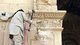 Islamic State / Syria: An ISIL militant uses a sledgehammer to destroy part of a Roman Era arch at Palmyra, April 2015