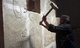 Islamic State / Iraq: An ISIL militant uses a sledgehammer to destroy a bas relief on a wall in Nimrud (1350 - 610 BCE) an ancient Assyrian city in Mosul, northern Iraq, March 2015