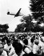Japan: USAF military transport plane flies over a student sit-in in protest against the expansion of a US military base, Tachikawa, Tokyo. Ken Domon (1909 - 1990), 1955