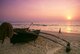 India: A traditional Goan outrigger fishing boat sits on the beach at Calangute Beach, North Goa