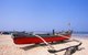 India: A traditional Goan outrigger fishing boat sits on the beach at Benaulim Beach, South Goa