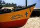India: The colourful prow of a traditional Goan outrigger fishing boat indicating the Christian faith of its owner, sits on Benaulim Beach, South Goa