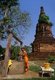 Thailand: A Buddhist monk raises a bucket of water from the well in his monastery, Phrae, Northern Thailand